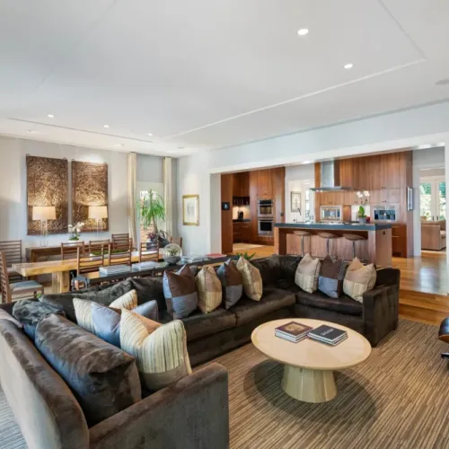 Stylish living room w/ statement round wood coffee table at the center