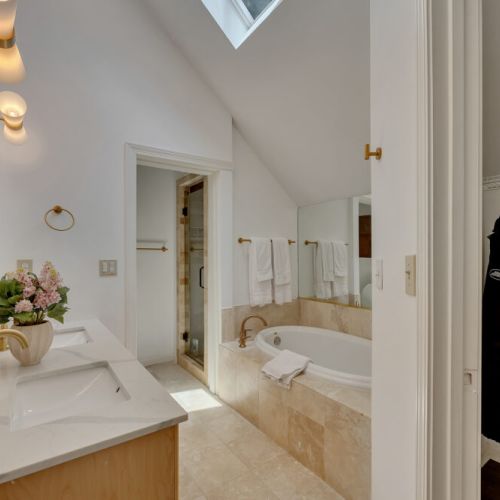 displays a bright and luxurious master bathroom