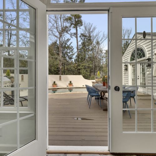 Glass doors open to seamless indoor-outdoor dining & pool access