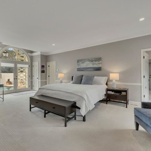 Calm bedroom w/ soft tones, cozy bed & restful atmosphere