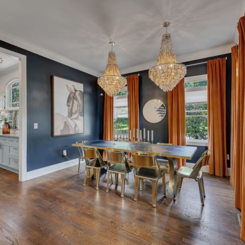 High drama in the dining room! Loving the bold contrast between the navy walls and orange curtains.
