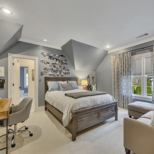 Bedroom 2 - Stylish wooden queen bed with plush bedding and layered pillows