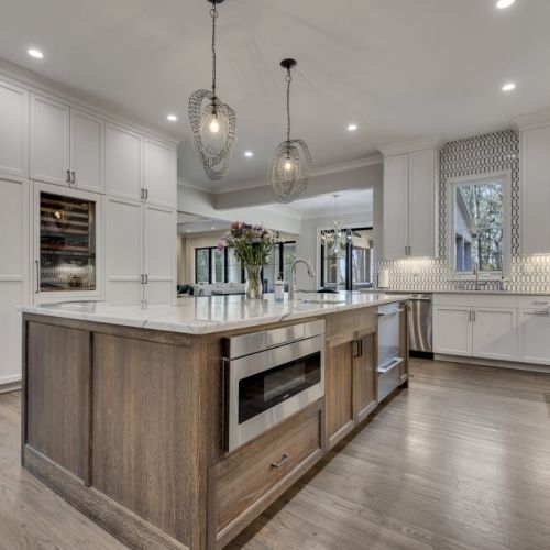 Stylish kitchen w/ island storage & pendant lights adding warmth & function