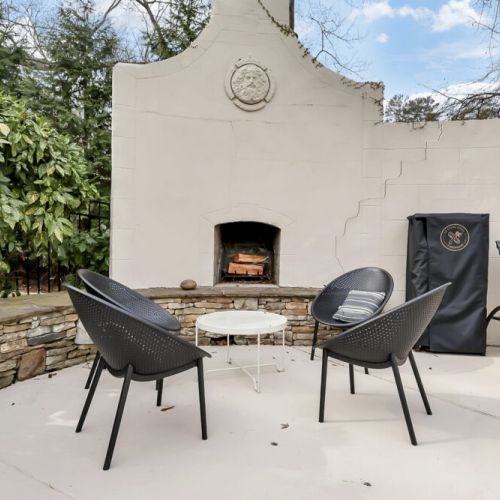 Cozy outdoor fireplace setup w/ seating, perfect for relaxed evenings