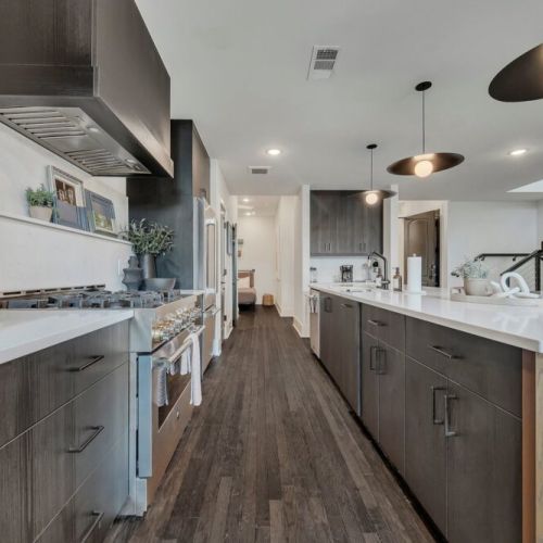 Spacious modern kitchen featuring sleek cabinetry, a large island, stainless steel appliances, and plenty of counter space for preparing and enjoying meals.