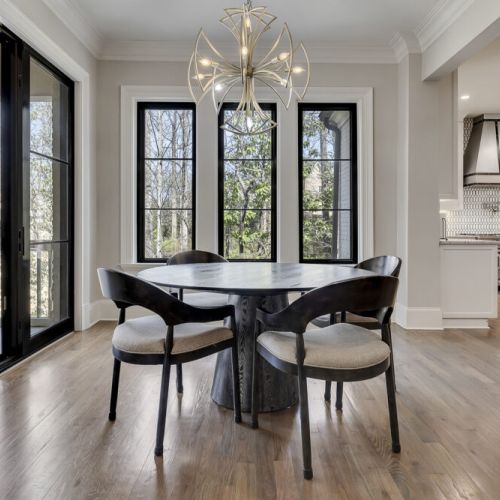 Sunlit breakfast area w/ large windows & intimate dining setup