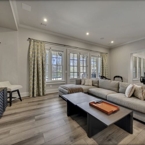 Lower level living room w/ sectional seating & soft lighting for movie nights