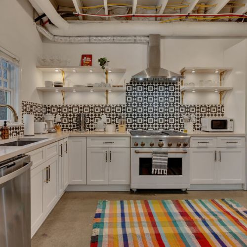 Kitchen, dining, and games all in one vibrant, open-concept basement.