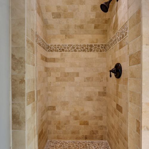 A vase with a bouquet of light pink and white flowers sits on the countertop
